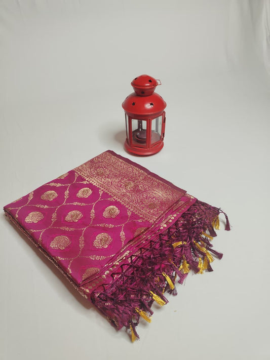 Exquisite Banarasi Saree with blouse, featuring golden zari work and tasselled pallu for a regal festive look.